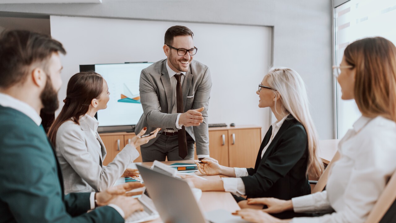 Leader talking to table of employees