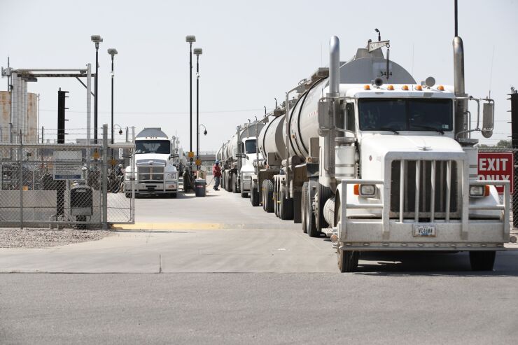 Raw crude oil is off-loaded from tanker trucks to be refined into gasoline at a Marathon Petroleum oil refinery during a driver shortage in Salt Lake City on July 15, 2021.