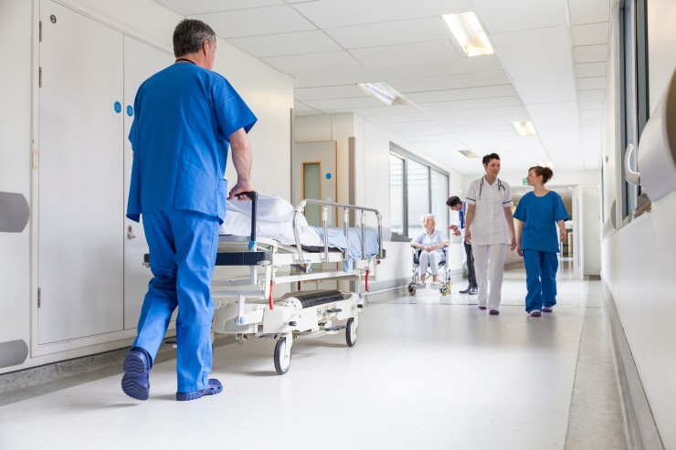 Doctors Hospital Corridor Nurse Pushing Gurney Stretcher Bed.