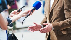 media reporter with microphone making journalist interview for news