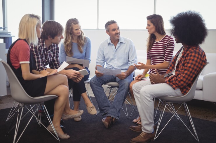 Group of employees in office talking
