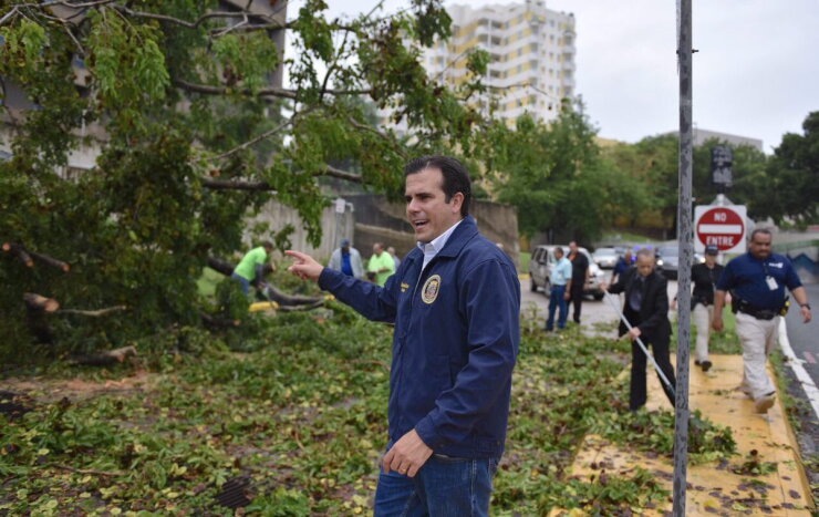Rossello next to Hurricane Irma damage