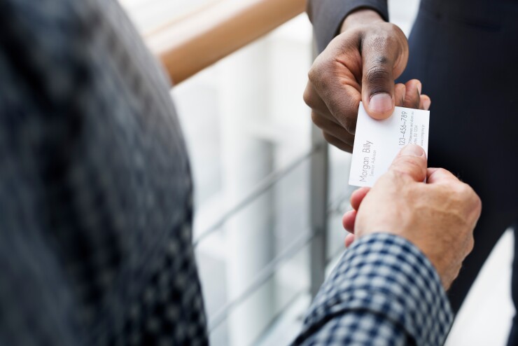 Person handing out his business card