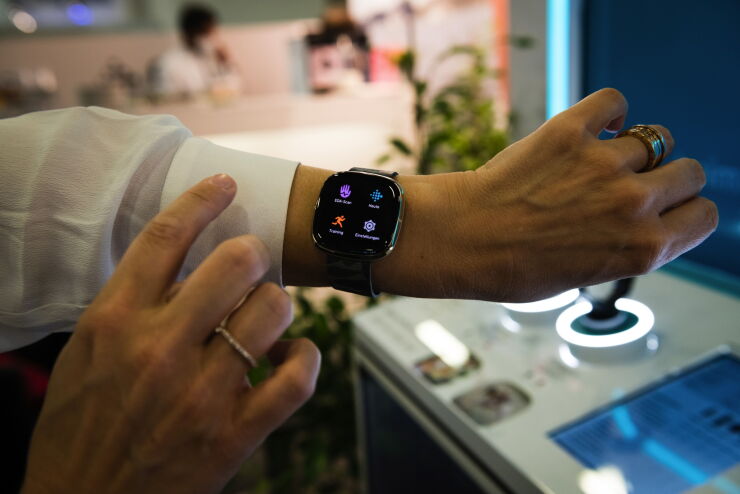 An employee demonstrates features on a Fitbit Inc. wearable device at the IFA Consumer Electronics Show at the Berlin Messe exhibition hall in Berlin, Germany, on Friday, Sept. 4, 2020. The electronics sector has found a way to thrive amid the global pandemic, with 5G demand helping the industry remain a rare catalyst for Asian factories. Photographer: Jacobia Dahm/Bloomberg