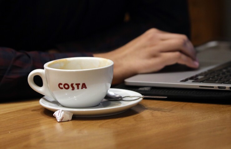 Costa coffee cup with computer