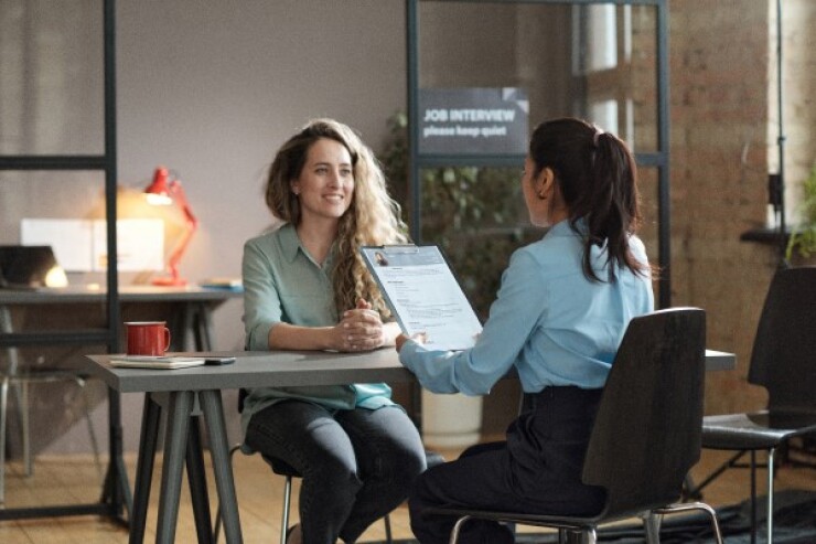 Person being interviewed for a job at a desk