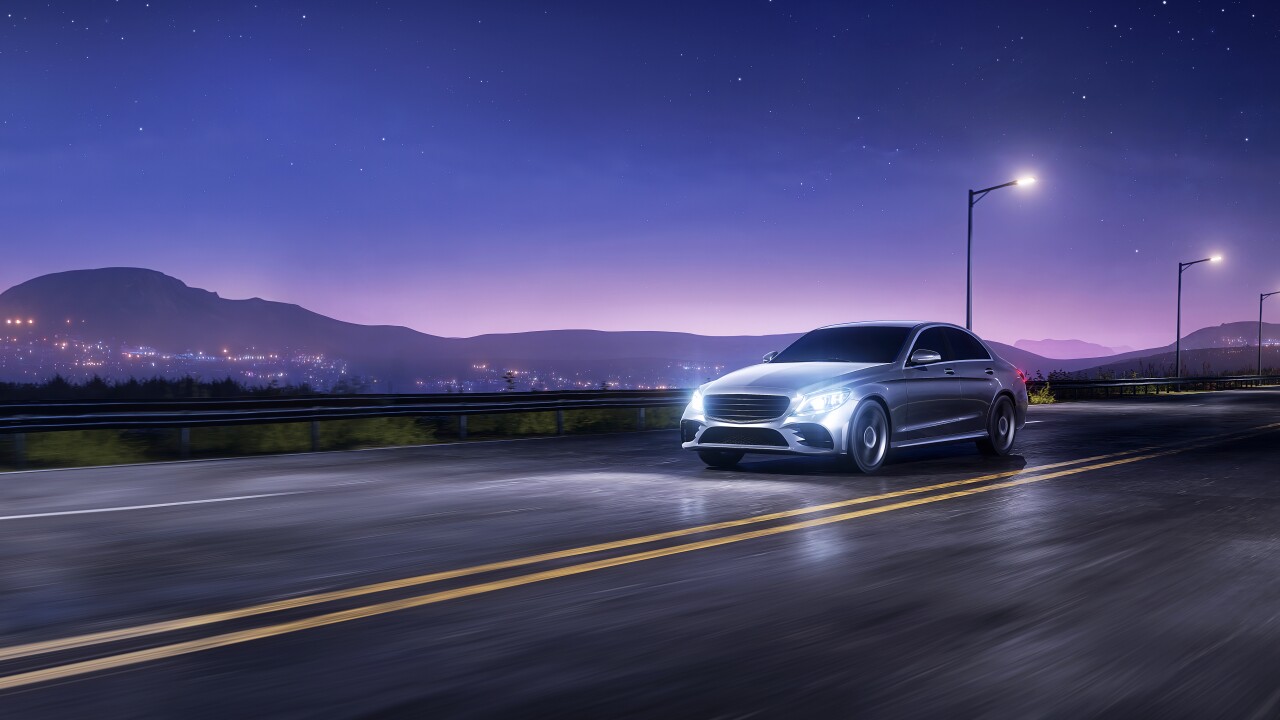 Car driving on a road at dusk