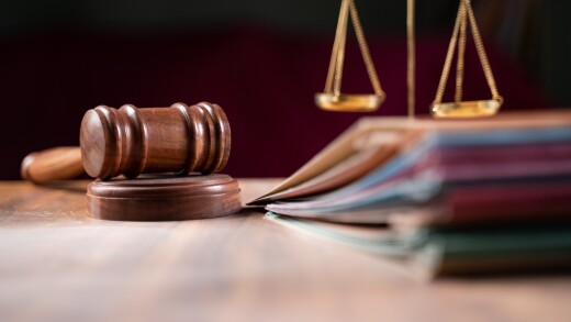 focus on hammer, group of files on judge table covered with dust - concept of pending old cases or work at judicial court