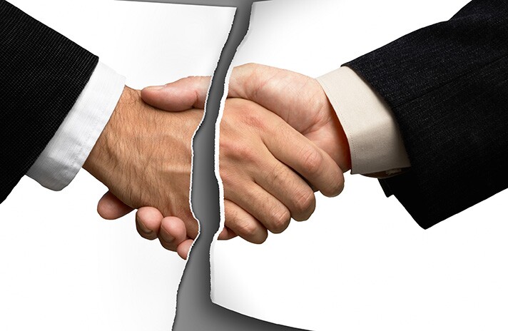 Photo of handshake deal torn in half.