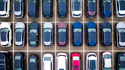A grid of multicolor cars in a parking lot
