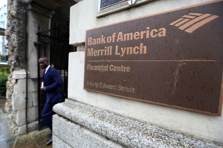 Man walking past entrance Bank of America Merrill Lynch in London Oct. 9, 2014 Bloomberg News