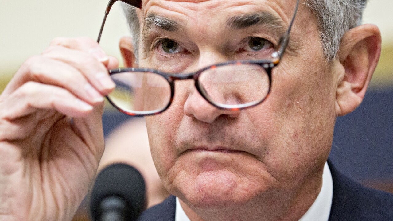Jerome Powell, chairman of the Federal Reserve, puts on his glasses during a House Financial Services Committee hearing in Washington.