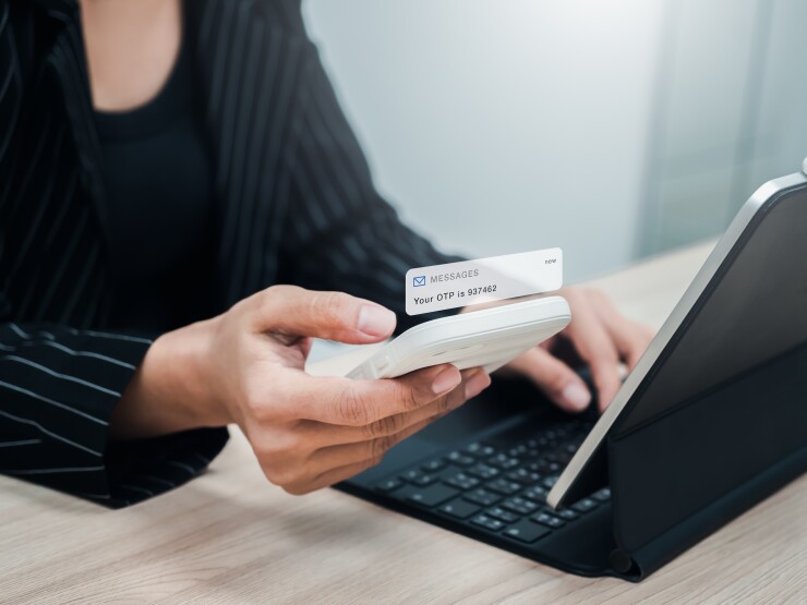 Two steps authentication, validate password, cybersecurity technology concept. OTP password code, sms alert showing on mobile smart phone in businesswoman hand while login with laptop computer.