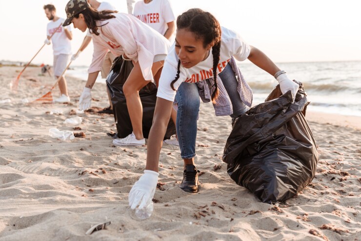 Volunteers picking up trash on beach