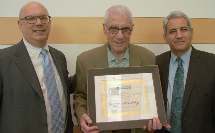 George Savitsky, CPA , of the Beverly Hills firm of Savitsky Satin Bacon Bucci, accepts the Entertainment Accountant of the Year Award from Bill Harris (left) and Ilan Haimoff, co-chairs of the annual CalCPA Education Foundation Entertainment Industry Conference on June 20.