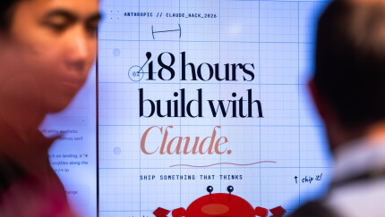 A large screen displays the text '48 hours build with Claude.'