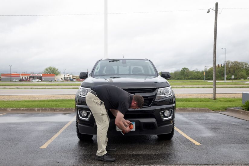 A salesman puts a license plate on a pre-owned 2018 Chevrolet Colorado pickup truck at the Green Chevrolet dealership in East Moline, Illinois, U.S., on Monday, May 3, 2021. General Motors Co. is scheduled to release earnings figures on May 5. Photographer: Daniel Acker/Bloomberg