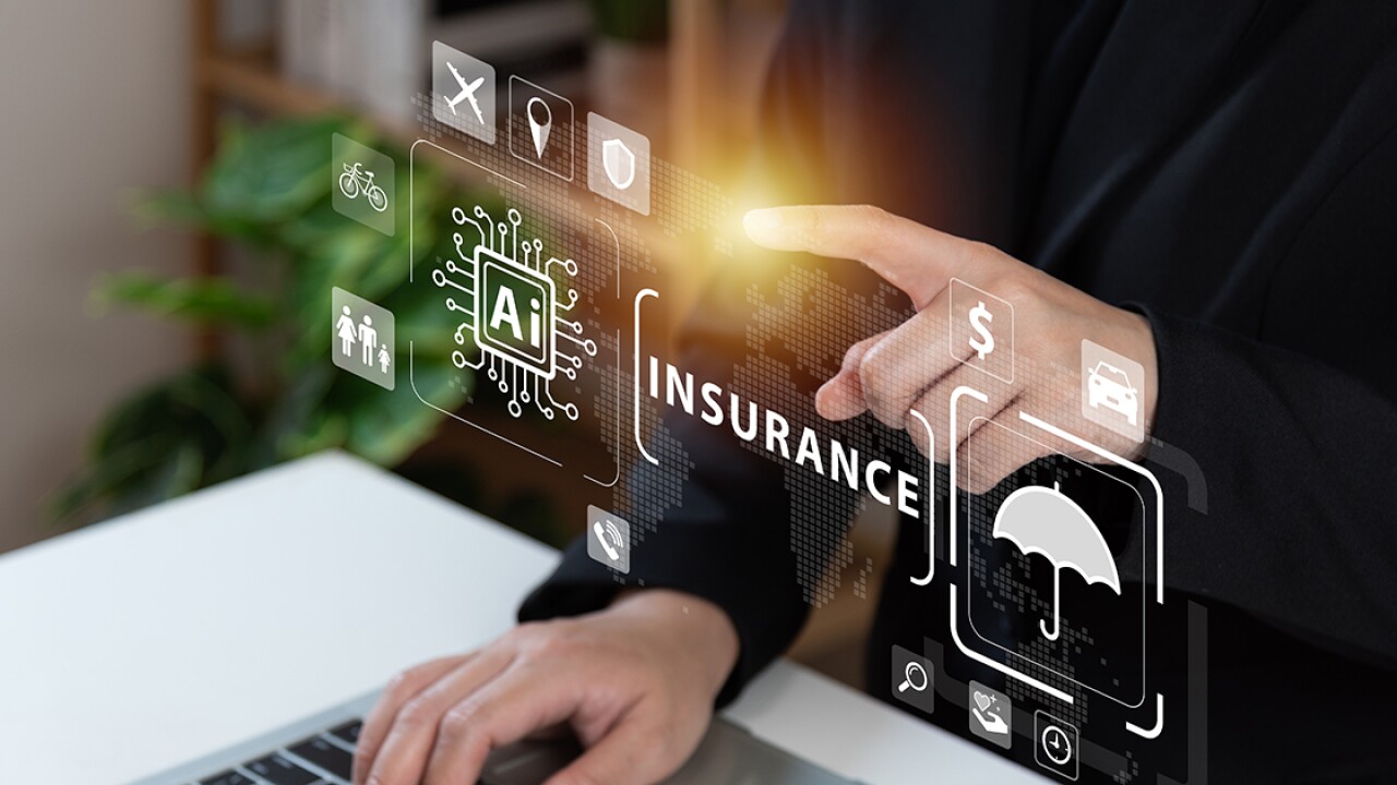 Images for AI and insurance floating above a laptop keyboard.