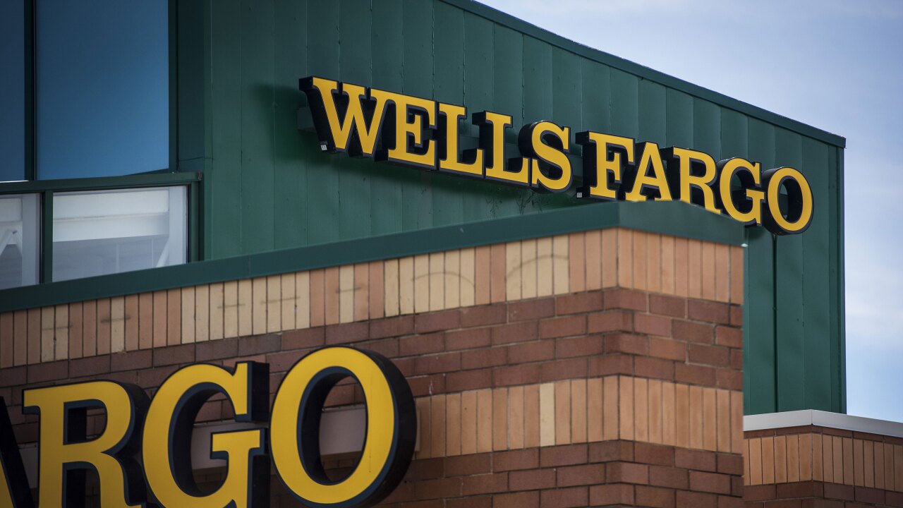 Signage is displayed outside a Wells Fargo bank branch in Palatine, Illinois.