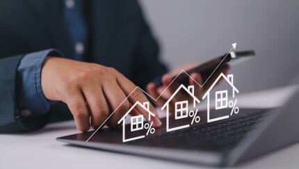 Real estate investment concept. Person using laptop with house icon and growth graph. Analyzing mortgage loan home and insurance real property mortgage. interest rate, Investment planning.