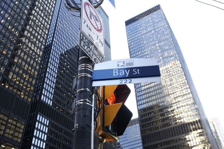 A "Bay Street" sign is displayed in the financial district of Toronto.