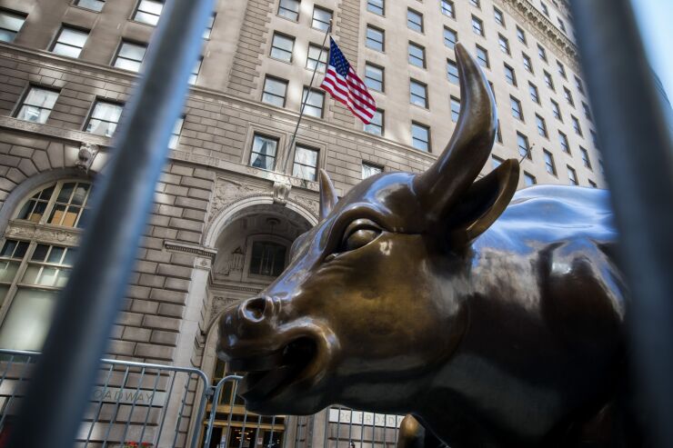 Charging Bull statue stands near the New York Stock Exchange on June 17, 2020