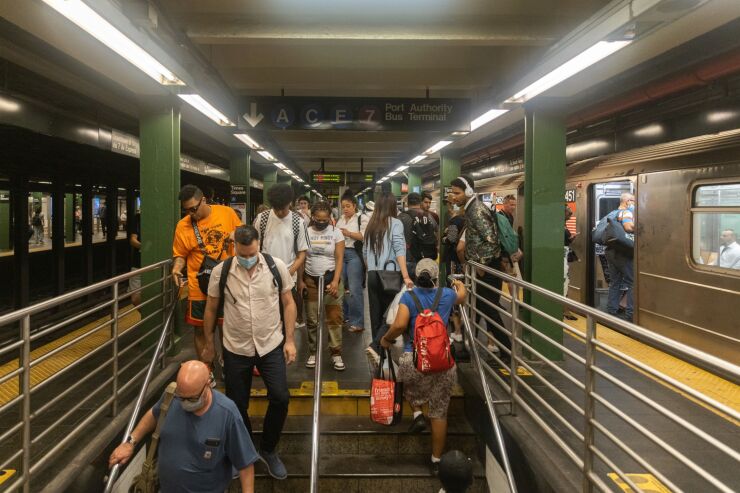 Commuters exit a subway station in New York, US, on Thursday, June 30, 2022. The head of New York's Metropolitan Transportation Authority warned the agency's anticipated $2 billion budget gap may widen in 2026 as it struggles to win back riders. Photographer: Jeenah Moon/Bloomberg