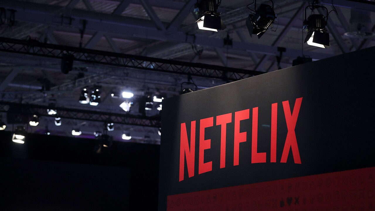 A Netflix Inc. logo sits on the online television streaming company's exhibition area at the Gamescom gaming industry event in Cologne, Germany, on Tuesday, Aug. 20, 2019. Photographer: Krisztian Bocsi/Bloomberg