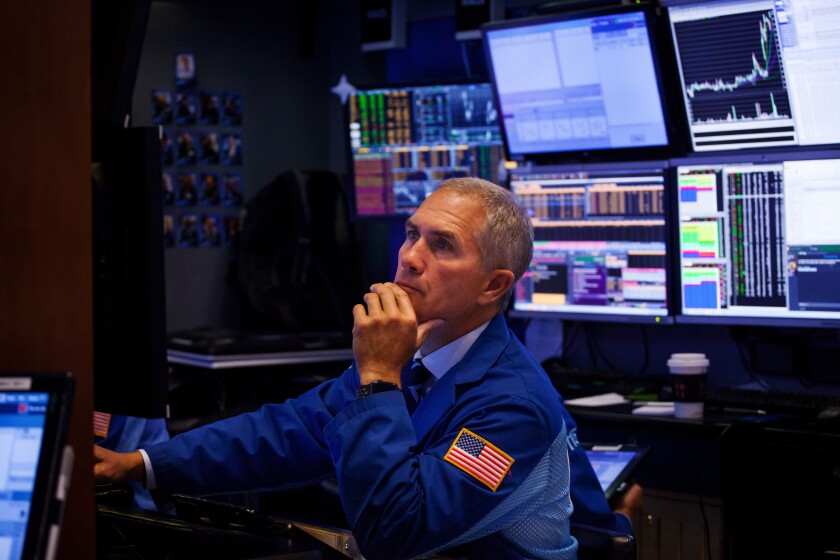 A trader works on the floor of the New York Stock Exchange (NYSE) in New York, U.S., on Monday, Sept. 10, 2018. Stocks held early gains even as shares of Apple and Asia-based suppliers slumped after President Donald Trump insisted his trade war with China will spur more manufacturing jobs in the U.S. Photographer: Michael Nagle/Bloomberg