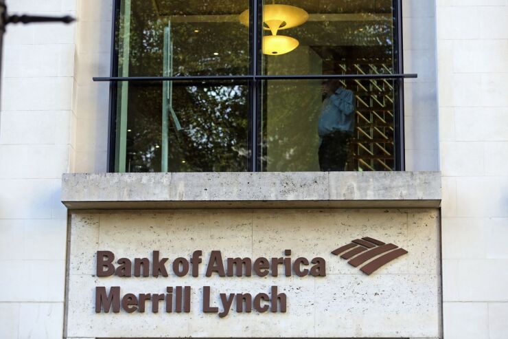 Ssign sits beneath an office window at the Bank of America Merrill Lynch Financial Centre in London, Oct. 9, 2014. Norway's sovereign wealth fund Norges Bank Investment Management, the world's largest, agreed to buy the Bank of America Merrill Lynch Financial Centre in London for 582.5 million pounds ($944 million) as it expands its bet on the U.K. capital. Photographer: Chris Ratcliffe/Bloomberg