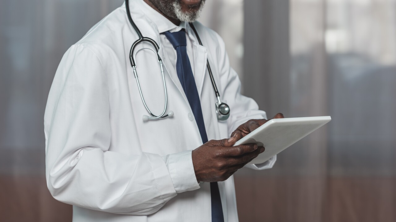 Doctor, office and tablet for research, email or communication. Medic, hospital and reading article, data or health magazine on web, while working with technology in healthcare center or clinic.