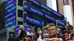 People sit across from Morgan Stanley headquarters in New York, U.S., on Thursday, July 12, 2018. Morgan Stanley is scheduled to release earnings figures on July 18. Photographer: Bess Adler/Bloomberg