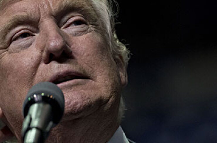 Donald Trump speaking into a microphone.