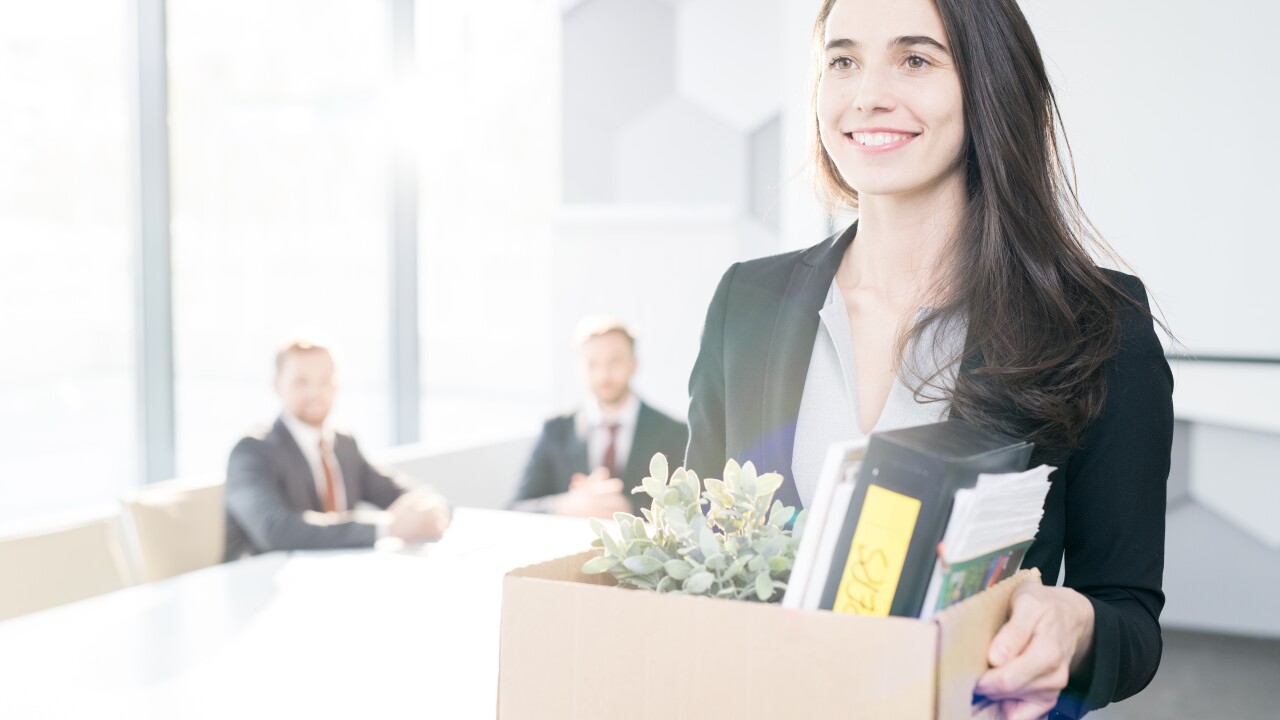 Happy woman packing box to leave job