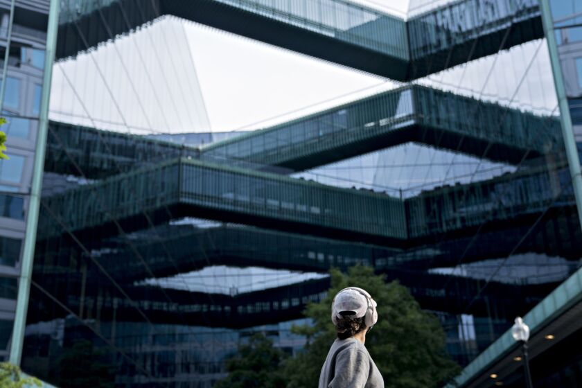 A pedestrian walks near the building that houses the Fannie Mae headquarters in Washington on May 8, 2020.