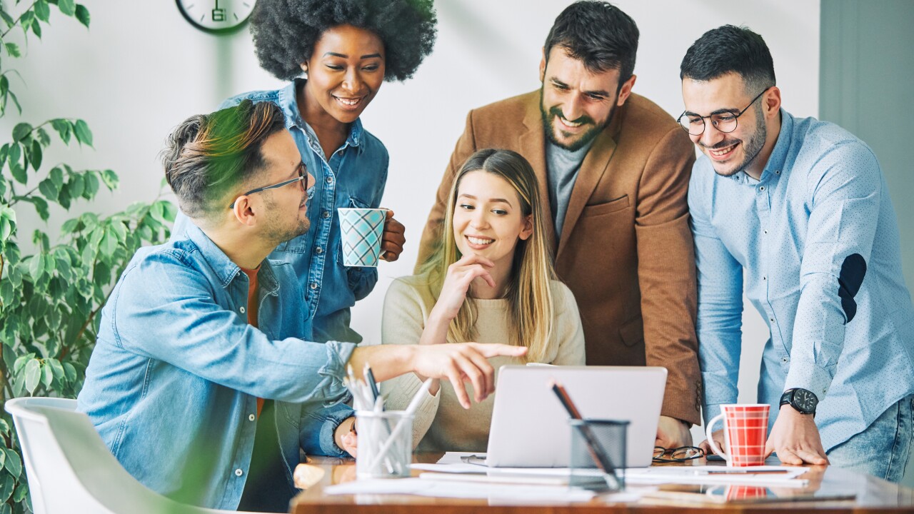 Group of employees talkin around table