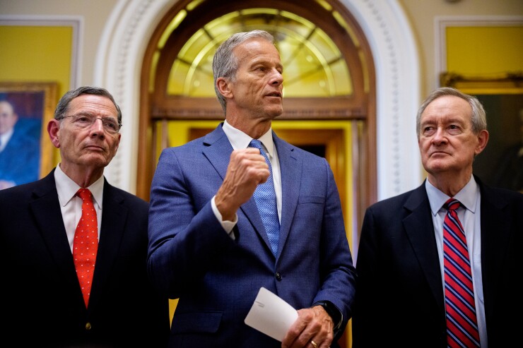 Senate Majority Leader John Thune, center, accompanied by Sen. John Barrasso, left, and Sen. Mike Crapo, speak to reporters after the Senate passes the tax bill at the U.S. Capitol in Washington, D.C., on July 1.