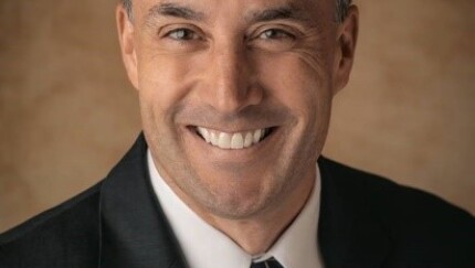 A man smiling for a portrait.