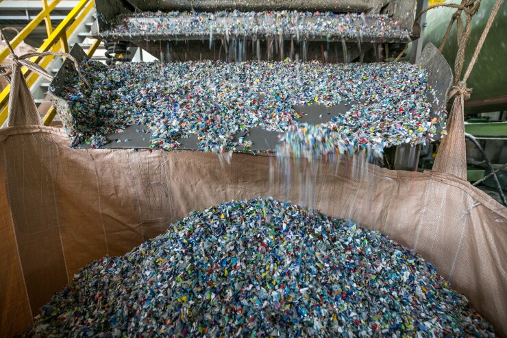Plastic bottle waste is shredded at a facility