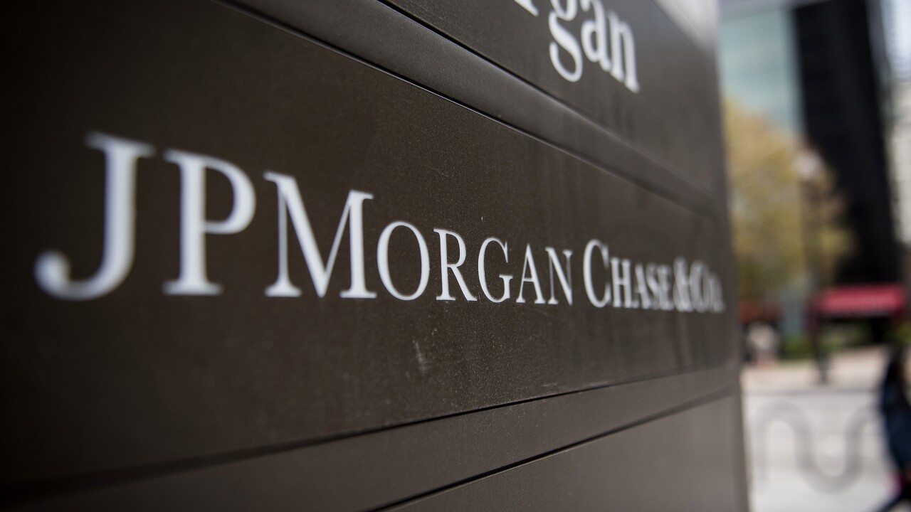 Signage stands on display outside the JPMorgan & Chase Tower in downtown Chicago, Illinois, U.S., on Saturday, Oct. 7, 2017. AKA J.P. Morgan.