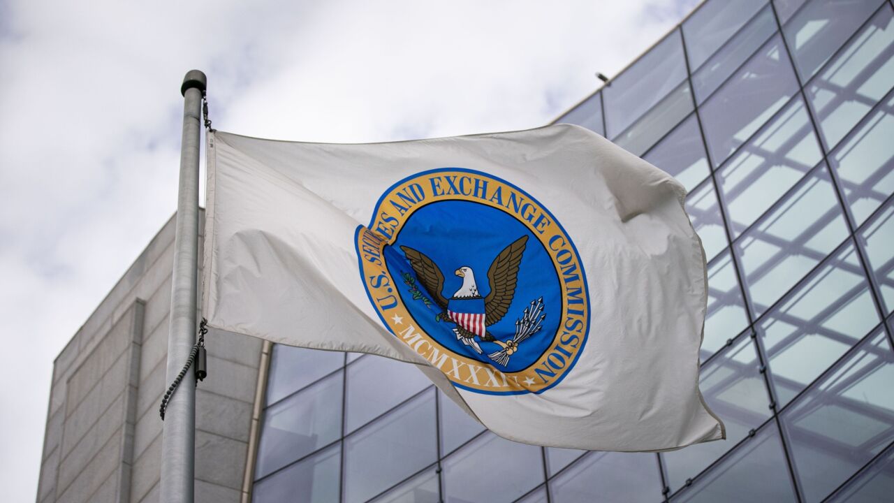 The Securities and Exchange Commission flag flies in front of a building. 