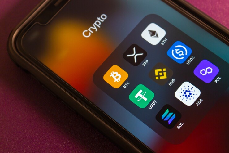 BTC (Bitcoin) and other cryptocurrency icons are displayed on an iPhone. Popular crypto concept, highlighting DeFi and the growing influence of digital currencies.