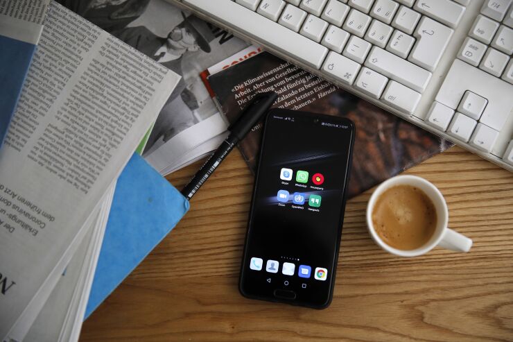 A smartphone sits next to a cup of espresso on the desk of a home office in an arranged photograph taken in Bern, Switzerland, on Wednesday, April 1, 2020. The Covid-19 pandemic has triggered a seismic wave of health awareness and anxiety, which is energizing a new category of virus-fighting tech and apps. Photographer: Stefan Wermuth/Bloomberg