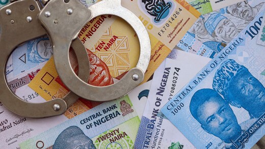 Nigerian naira currency money bills and handcuffs. The concept of criminal