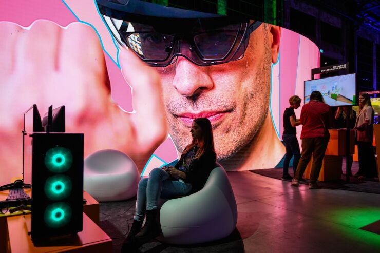 An attendee plays a computer game, center, as others interact with digital displays at the Reply SpA exhibition stand at the Italian Tech Week forum in Turin, Italy, on Friday, Sept. 30, 2022. Exor NV Chief Executive Officer John Elkann said he sees potential for startups and tech in Italy, where the family’s Fiat SpA once dominated a manufacturing-heavy industrial landscape. Photographer: Giuliano Berti/Bloomberg