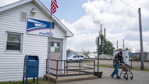 A person leaves a United States Post Office location, in front of the Conesville Power Plant in Conesville, Ohio, on April 18, 2020.