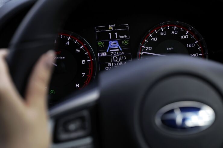 An instrument panel of a prototype Subaru Corp. Levorg vehicle displays the information of the company's EyeSight driving support system as a journalist drives the vehicle during a test drive at Japan Automobile Research Institute's (JARI) Shirosato Test Center in Shirosato, Ibaraki, Japan, on Thursday, June 15, 2017. The EyeSight technology warns drivers when there is potential danger and can apply brakes.