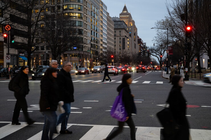 Pedestrians cross a street in Washington, D.C.