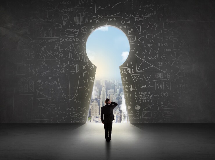 Business man looking at keyhole with bright cityscape concept