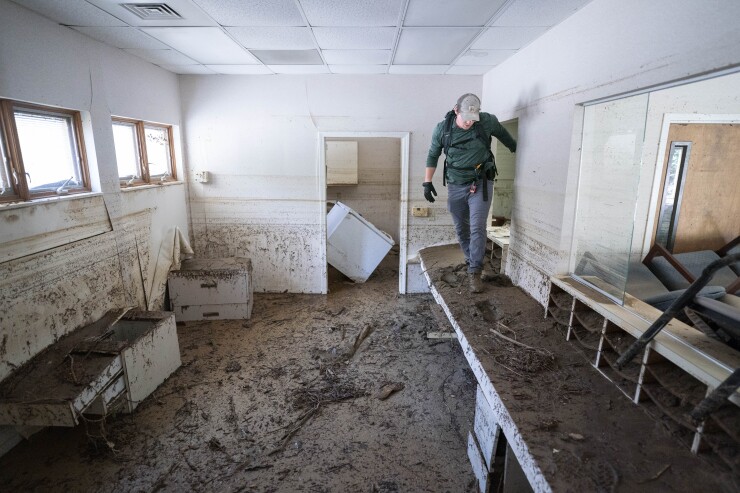 A search and rescue team member inspects a building in the aftermath of Hurricane Helene in Bat Cave, North Carolina, on Oct. 1.